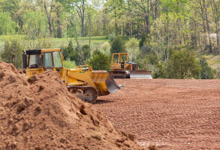 Large earth mover digger clearing land